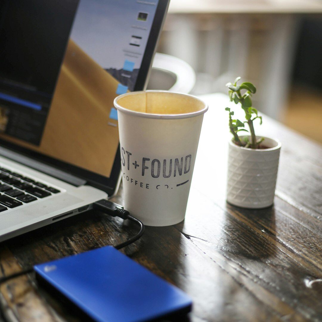 Overhead view of a desk with insurance documents, a laptop and a cup of coffee