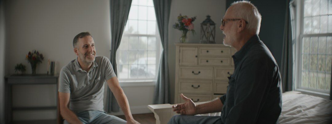 Insurance agent explaining a health plan brochure to a senior client